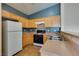 Full kitchen view features an oven, wood cabinets and tile floor at 6576 Buster Brown Ave # 101, Las Vegas, NV 89122