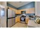 Kitchen featuring stainless appliances, ample counter space, and neutral tones at 6576 Buster Brown Ave # 101, Las Vegas, NV 89122