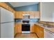 A full kitchen view featuring an oven, wood cabinets and tile floor at 6576 Buster Brown Ave # 101, Las Vegas, NV 89122