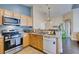 Kitchen featuring stainless steel appliances, natural wood cabinets, and modern faucet at 6576 Buster Brown Ave # 101, Las Vegas, NV 89122