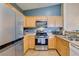 Stainless steel appliances complement the bright kitchen with natural wood cabinets at 6576 Buster Brown Ave # 101, Las Vegas, NV 89122