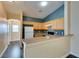 Kitchen features wood cabinets and a breakfast bar open to the dining area at 6576 Buster Brown Ave # 101, Las Vegas, NV 89122