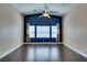Bright living room boasts an accent wall, ceiling fan, and durable wood flooring for cozy living at 6576 Buster Brown Ave # 101, Las Vegas, NV 89122