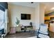 Cozy living room features modern furniture, sleek TV, and wood-look flooring at 6576 Buster Brown Ave # 101, Las Vegas, NV 89122