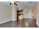 Expansive living room with durable wood flooring and an open layout leading to the kitchen and other living spaces at 6576 Buster Brown Ave # 101, Las Vegas, NV 89122