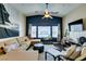 Comfortable living room features a large sectional sofa, dark accent wall, and ample natural light at 6576 Buster Brown Ave # 101, Las Vegas, NV 89122