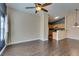 Cozy living room featuring a ceiling fan and durable wood flooring that continues into the adjacent kitchen at 6576 Buster Brown Ave # 101, Las Vegas, NV 89122