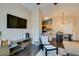 Comfortable living room with mounted tv, view of the kitchen and lots of seating at 6576 Buster Brown Ave # 101, Las Vegas, NV 89122