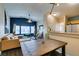 Open concept living room with dark wood floors and tan sectional sofa and view to kitchen at 6576 Buster Brown Ave # 101, Las Vegas, NV 89122
