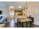 Beautiful view of the dining area showcasing hardwood floors, open layout, modern lighting, and adjoining kitchen at 6576 Buster Brown Ave # 101, Las Vegas, NV 89122