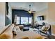 Comfortable living room with large windows, ceiling fan, and neutral-toned sectional sofa at 6576 Buster Brown Ave # 101, Las Vegas, NV 89122