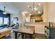 Cozy living area with an open layout, hardwood floors, modern lighting, and an adjoining kitchen at 6576 Buster Brown Ave # 101, Las Vegas, NV 89122