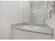 Bathroom featuring a granite countertop and large mirror at 664 Foam Flower Ln, Henderson, NV 89015