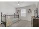 Cozy bedroom with metal frame bed, lots of natural light, and a modern dresser, creating a restful and inviting atmosphere at 664 Foam Flower Ln, Henderson, NV 89015