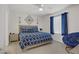 Bright bedroom with a modern ceiling fan and stylish blue accents for a fresh look at 664 Foam Flower Ln, Henderson, NV 89015