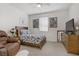 This bedroom features a wooden bed frame and dresser with a large TV at 664 Foam Flower Ln, Henderson, NV 89015