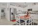 Bright kitchen features white cabinetry, stainless steel appliances, and a cozy dining area at 664 Foam Flower Ln, Henderson, NV 89015