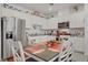 Modern kitchen featuring stainless steel appliances and a dining table with seating at 664 Foam Flower Ln, Henderson, NV 89015