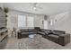 Bright living area with a modern black sofa and a stylish rug at 664 Foam Flower Ln, Henderson, NV 89015