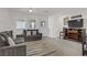 Comfortable living room featuring neutral tones and a cozy seating area at 664 Foam Flower Ln, Henderson, NV 89015