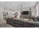Open-concept living space featuring a modern kitchen and a comfortable living room area at 664 Foam Flower Ln, Henderson, NV 89015
