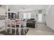 Bright living room features a modern dining area and comfortable leather furniture at 664 Foam Flower Ln, Henderson, NV 89015