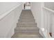 A bright, carpeted staircase leads to the upper level of the home at 664 Foam Flower Ln, Henderson, NV 89015