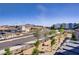 Community street view showcasing nearby businesses and well-kept landscaping at 664 Foam Flower Ln, Henderson, NV 89015