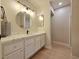 Bathroom with a new vanity featuring a quartz countertop, shaker cabinets, a round mirror, and updated lighting at 6853 Tamarus St # 202, Las Vegas, NV 89119