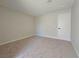Neutral carpeted bedroom with painted walls, modern base trim, and a closet at 6853 Tamarus St # 202, Las Vegas, NV 89119
