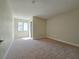 Neutral bedroom features plush carpeting, base trim, fresh paint, and natural light at 6853 Tamarus St # 202, Las Vegas, NV 89119