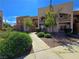 Attractive multi-story apartment building features well-maintained landscaping, sidewalks, and desert plants at 6853 Tamarus St # 202, Las Vegas, NV 89119