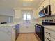 Stylish kitchen featuring stainless steel appliances, modern fixtures, and ample counter space at 6853 Tamarus St # 202, Las Vegas, NV 89119