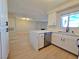 Open kitchen view highlights new appliances, white cabinets, and eat-in counter at 6853 Tamarus St # 202, Las Vegas, NV 89119