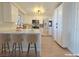 Modern kitchen boasts white cabinets, marble countertops, stainless steel appliances, and counter seating at 6853 Tamarus St # 202, Las Vegas, NV 89119