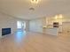 Bright living room features a fireplace, light wood floors, modern decor, and built-in kitchen bar at 6853 Tamarus St # 202, Las Vegas, NV 89119