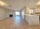 Bright living room features a fireplace, light wood floors, modern decor, and built-in kitchen bar at 6853 Tamarus St # 202, Las Vegas, NV 89119