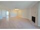 Inviting living room boasts a sleek fireplace, light wood flooring, and modern lighting fixture at 6853 Tamarus St # 202, Las Vegas, NV 89119