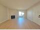 Bright living room featuring a fireplace, wood floors, and access to a balcony with natural light at 6853 Tamarus St # 202, Las Vegas, NV 89119