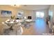 Bright living room features a fireplace, light wood floors, modern decor, and sliding glass doors at 6853 Tamarus St # 202, Las Vegas, NV 89119