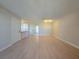 Open concept living area with wood floors and neutral decor leading to the kitchen at 6853 Tamarus St # 202, Las Vegas, NV 89119