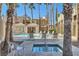 Relaxing community pool and hot tub area surrounded by tall palm trees at 6853 Tamarus St # 202, Las Vegas, NV 89119