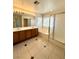 Bright bathroom featuring a double vanity, soaking tub, and glass enclosed shower at 7607 Pioneer Ranch Ave, Las Vegas, NV 89113