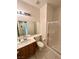 Well-lit bathroom featuring a vanity with a sink, toilet, and a glass-enclosed shower at 7607 Pioneer Ranch Ave, Las Vegas, NV 89113