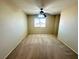 Cozy carpeted bedroom featuring neutral walls, and a ceiling fan at 7607 Pioneer Ranch Ave, Las Vegas, NV 89113