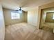 Bedroom with plush carpet, ceiling fan, and natural light from the window at 7607 Pioneer Ranch Ave, Las Vegas, NV 89113