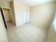 Bright bedroom with tile floors, closet with bi-fold doors, and a window with natural light at 7607 Pioneer Ranch Ave, Las Vegas, NV 89113