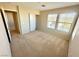 A bright bedroom featuring carpeted floors, dual windows, and a closet at 7607 Pioneer Ranch Ave, Las Vegas, NV 89113