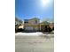 Two-story stucco home with a two-car garage and desert landscaping in front at 7607 Pioneer Ranch Ave, Las Vegas, NV 89113