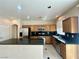 Traditional kitchen with granite countertops, wooden cabinets, and stainless steel appliances at 7607 Pioneer Ranch Ave, Las Vegas, NV 89113